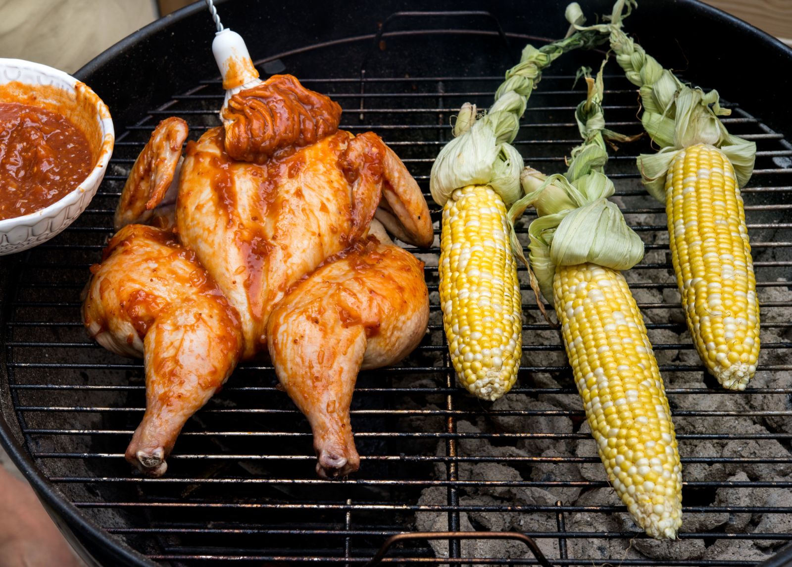 Cider-BBQ-Sauce-Brushed on-Whole-Chicken-Being-Grilled