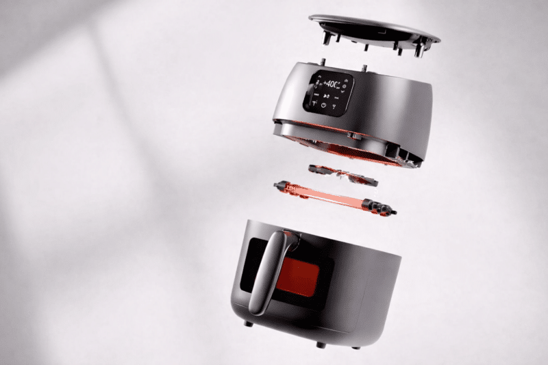 A digitally-enhanced image of the internal components of a high-tech air fryer from Dish Works Digital Studio